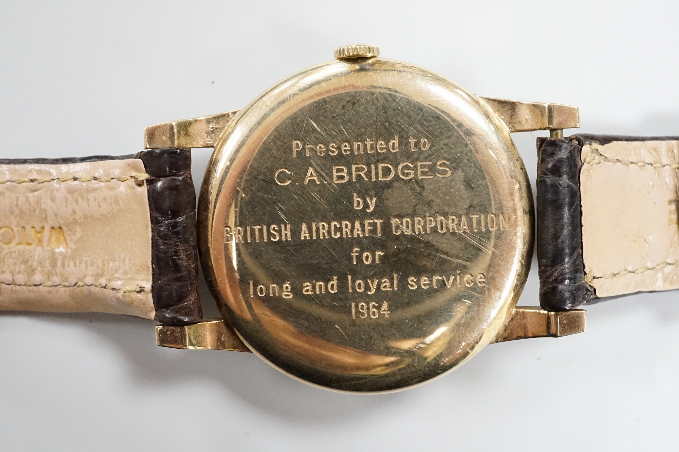 A gentleman's yellow metal Roamer manual wing wrist watch, with case back inscription, on a leather strap.